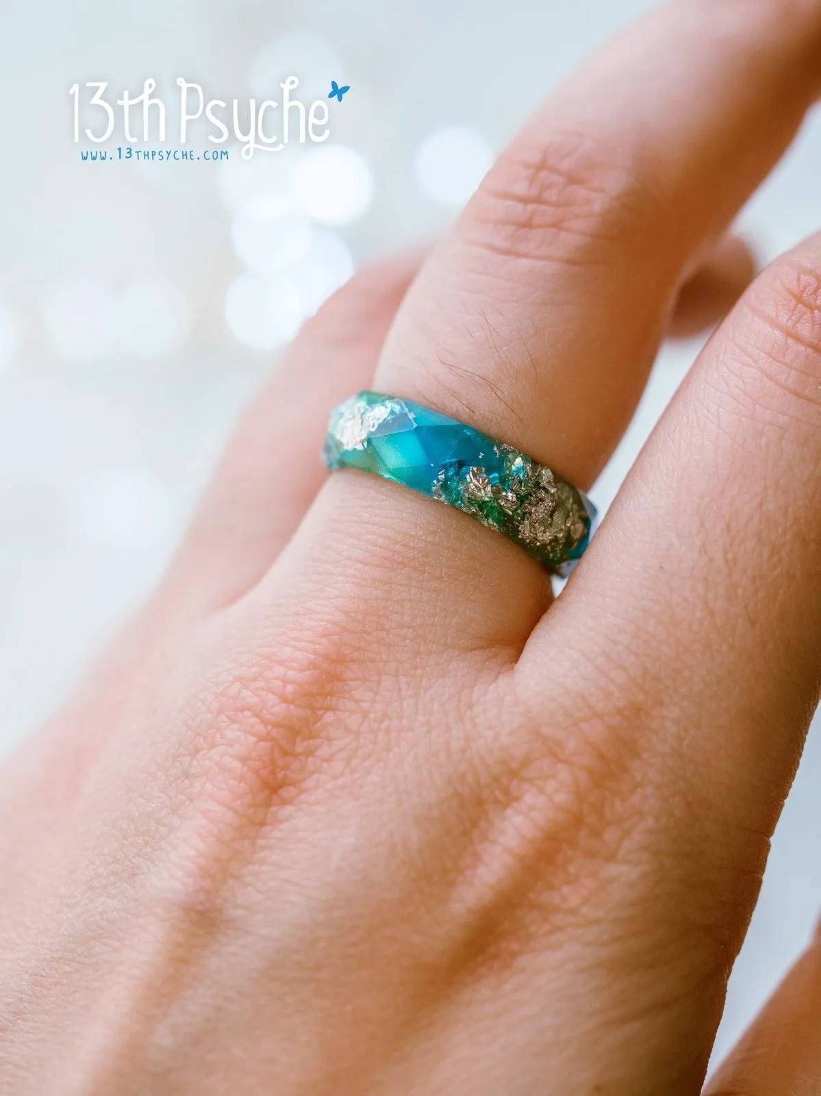 Clear blue and turquoise faceted resin ring with silver flakes