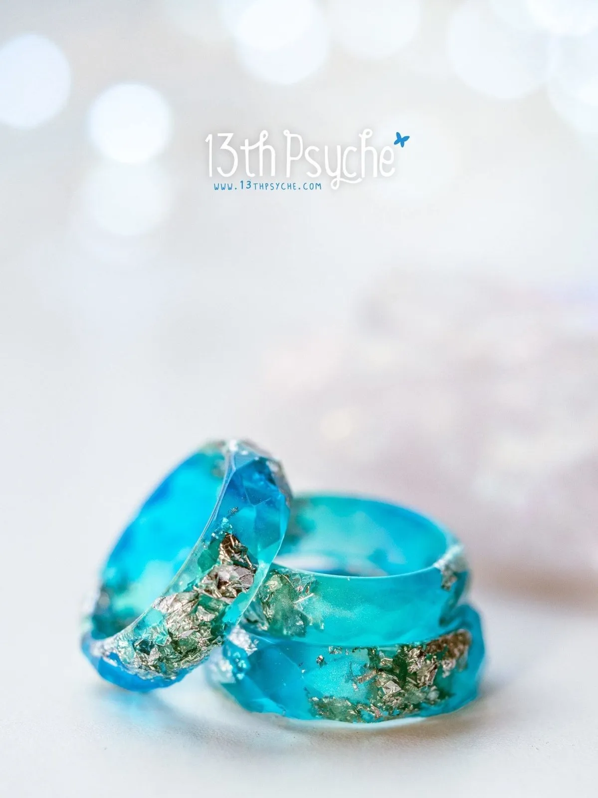 Clear blue and turquoise faceted resin ring with silver flakes